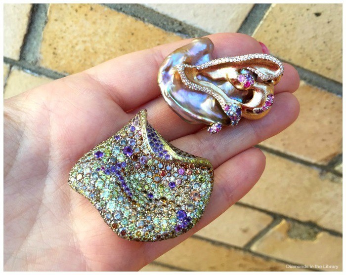 Two brooches by the fabulous Naomi Sarna Designs; colored sapphires, amethysts, and diamonds and a freshwater baroque cultured pearl.