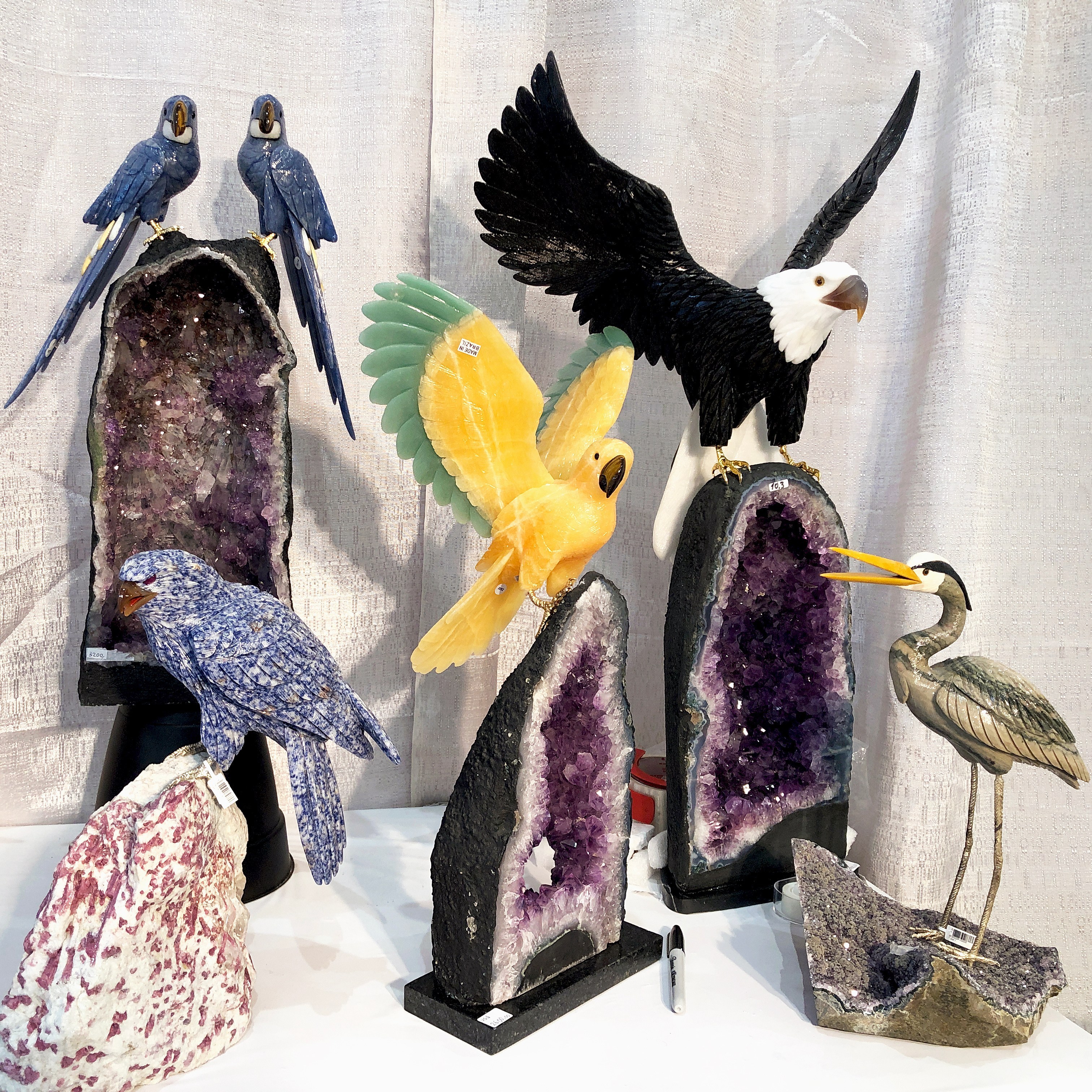 Incredible carved gemstone bird statues from BB Gems, some with amethyst geodes! Spotted at the 2019 AGTA GemFair.