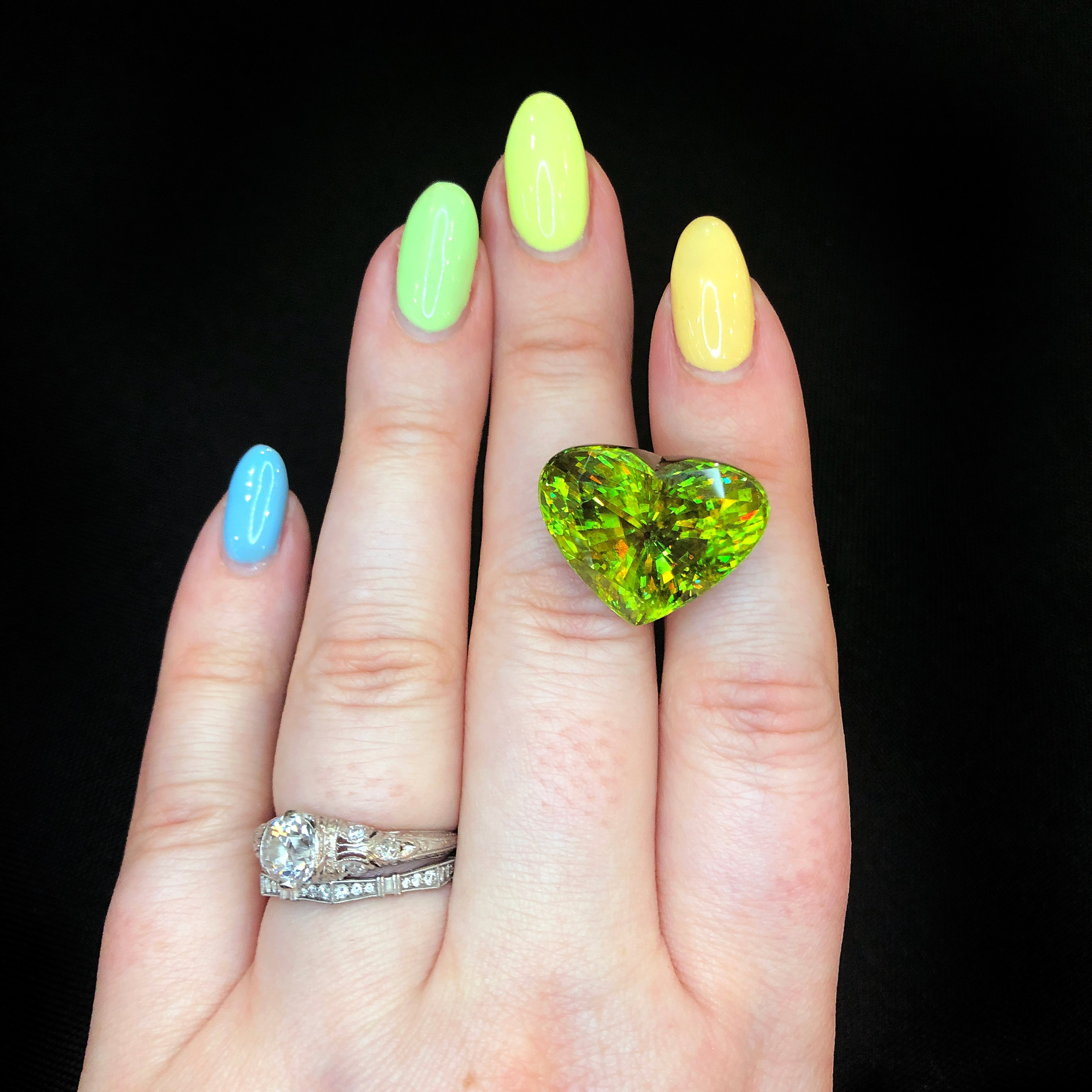 Sphene is a stunning green gemstone with orange flecks. This heart-shaped beauty is from Michael Couch.