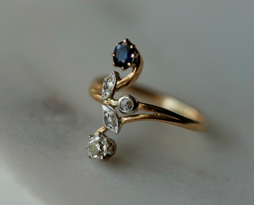 A beautiful antique ring with diamonds and a sapphire doublet.