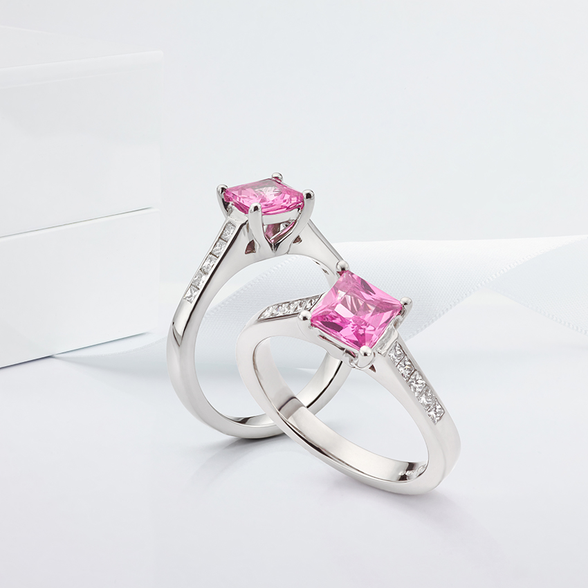 Pink fliss engagement ring shown with diamond shoulders and pink sapphire